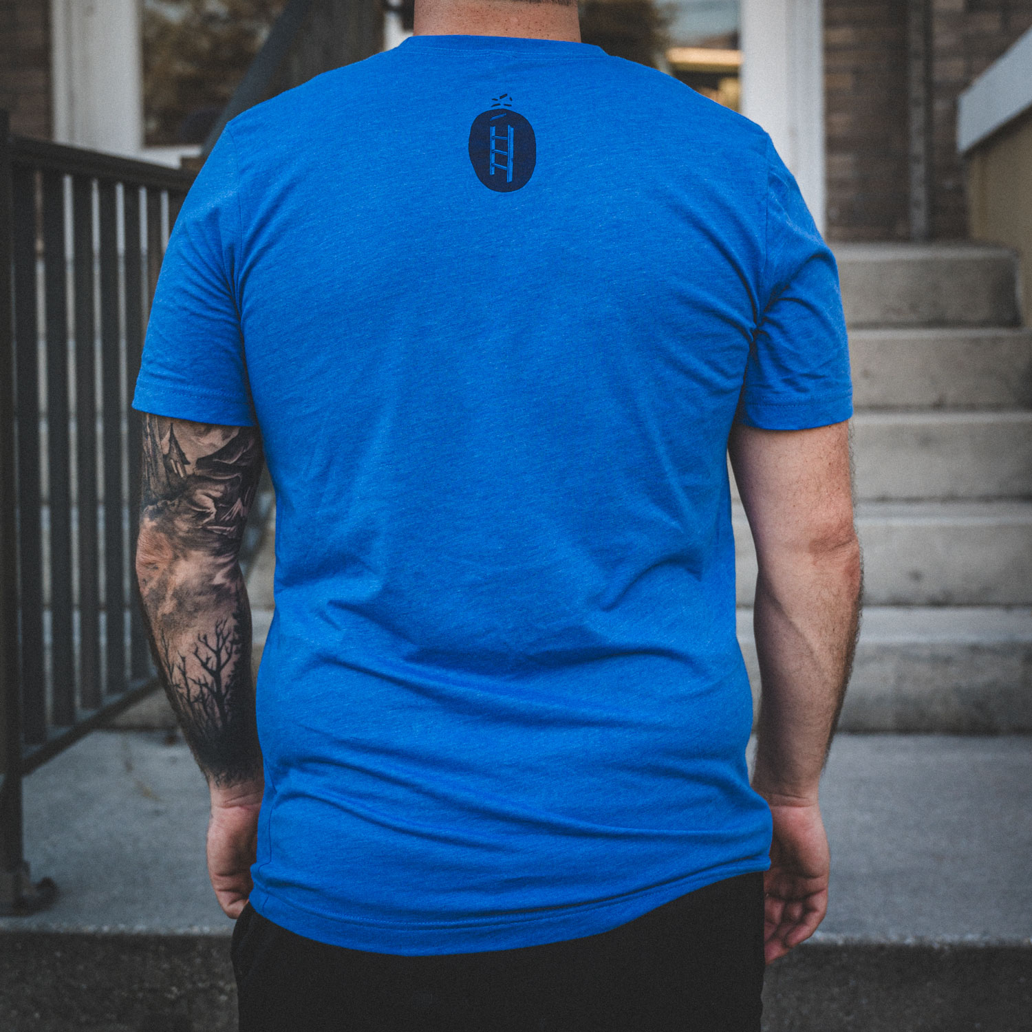 Blue Corporate Ladder Logo wordmark shirt with circle ladder logo on back.