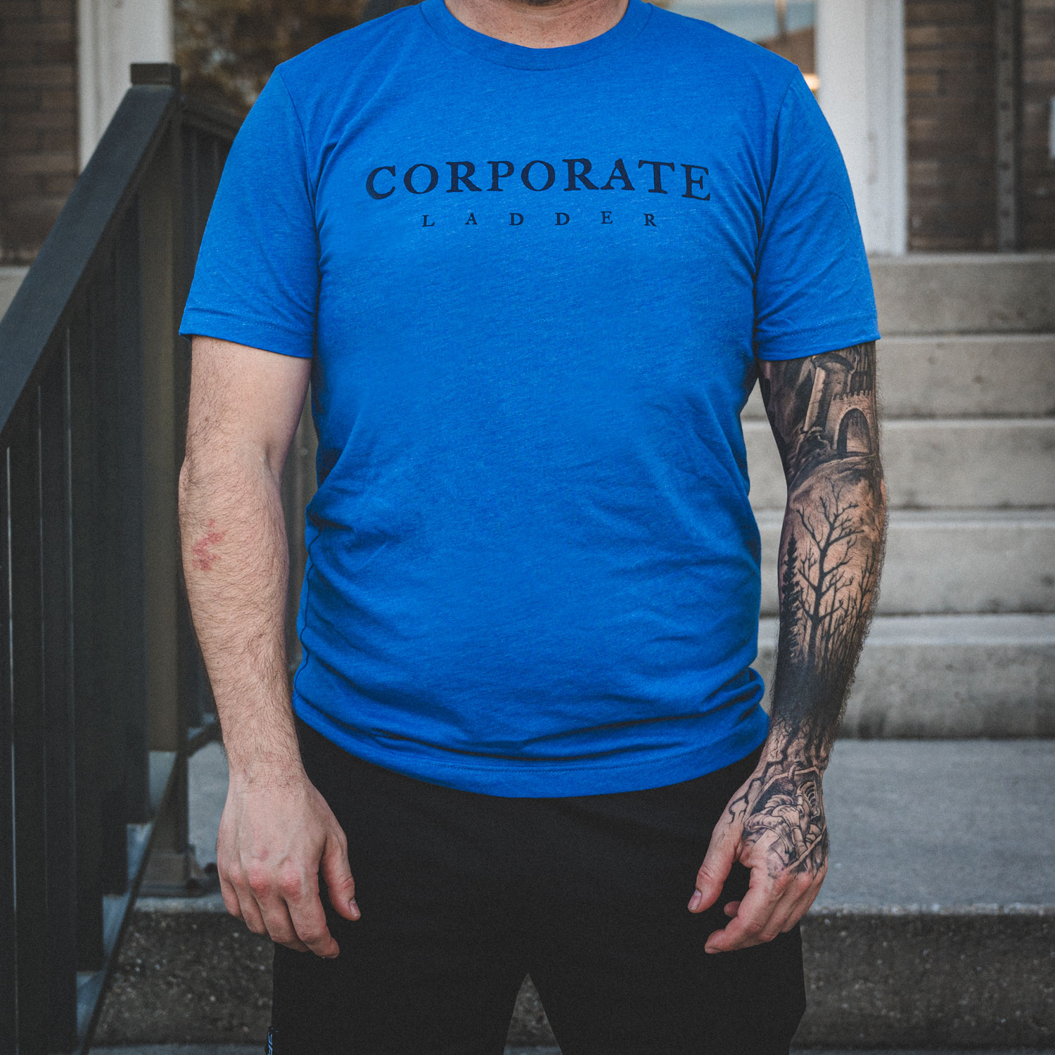 Blue Corporate Ladder Logo wordmark shirt with circle ladder logo on back.
