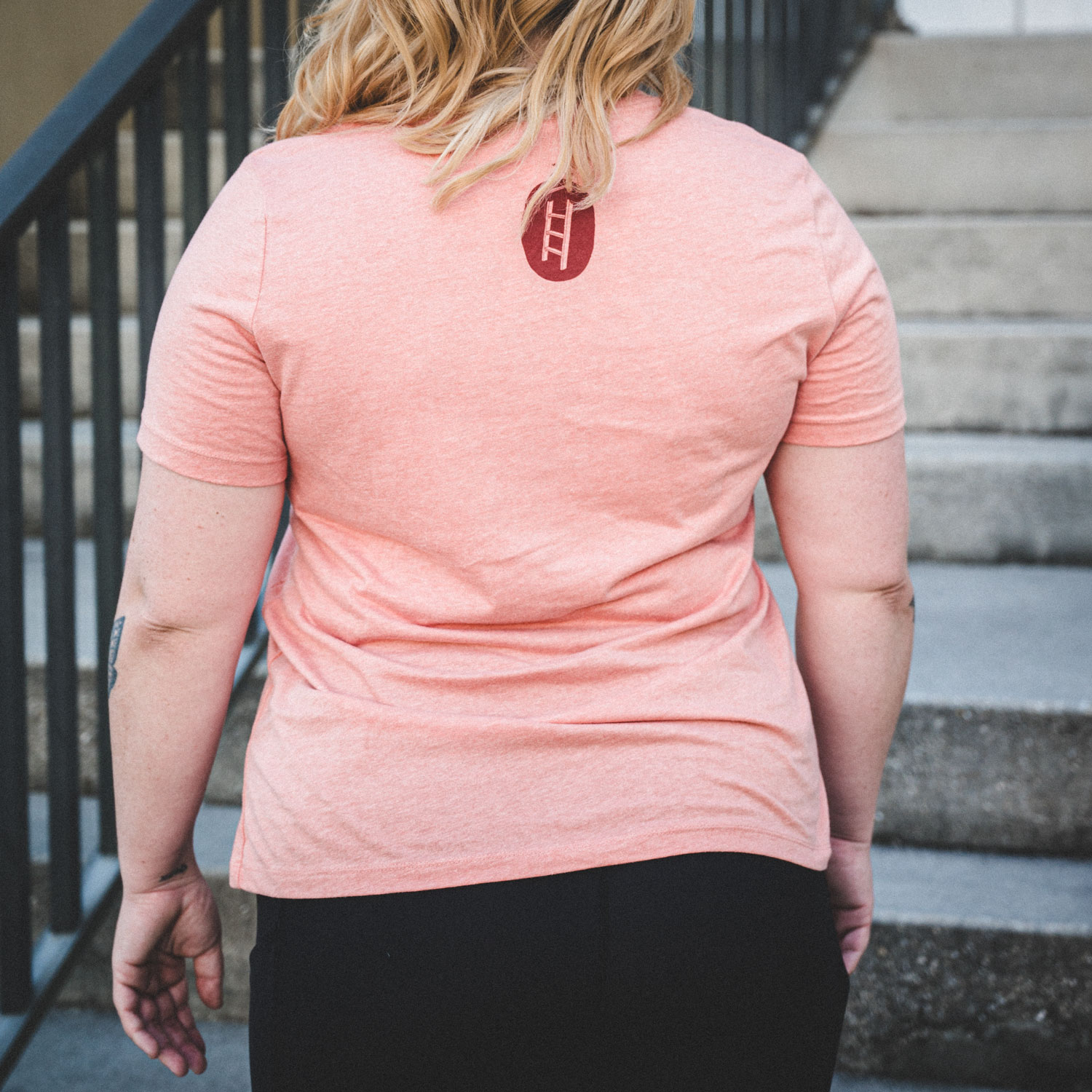 Women's Pink Corporate Ladder Wordmark Shirt with circle ladder logo on back.
