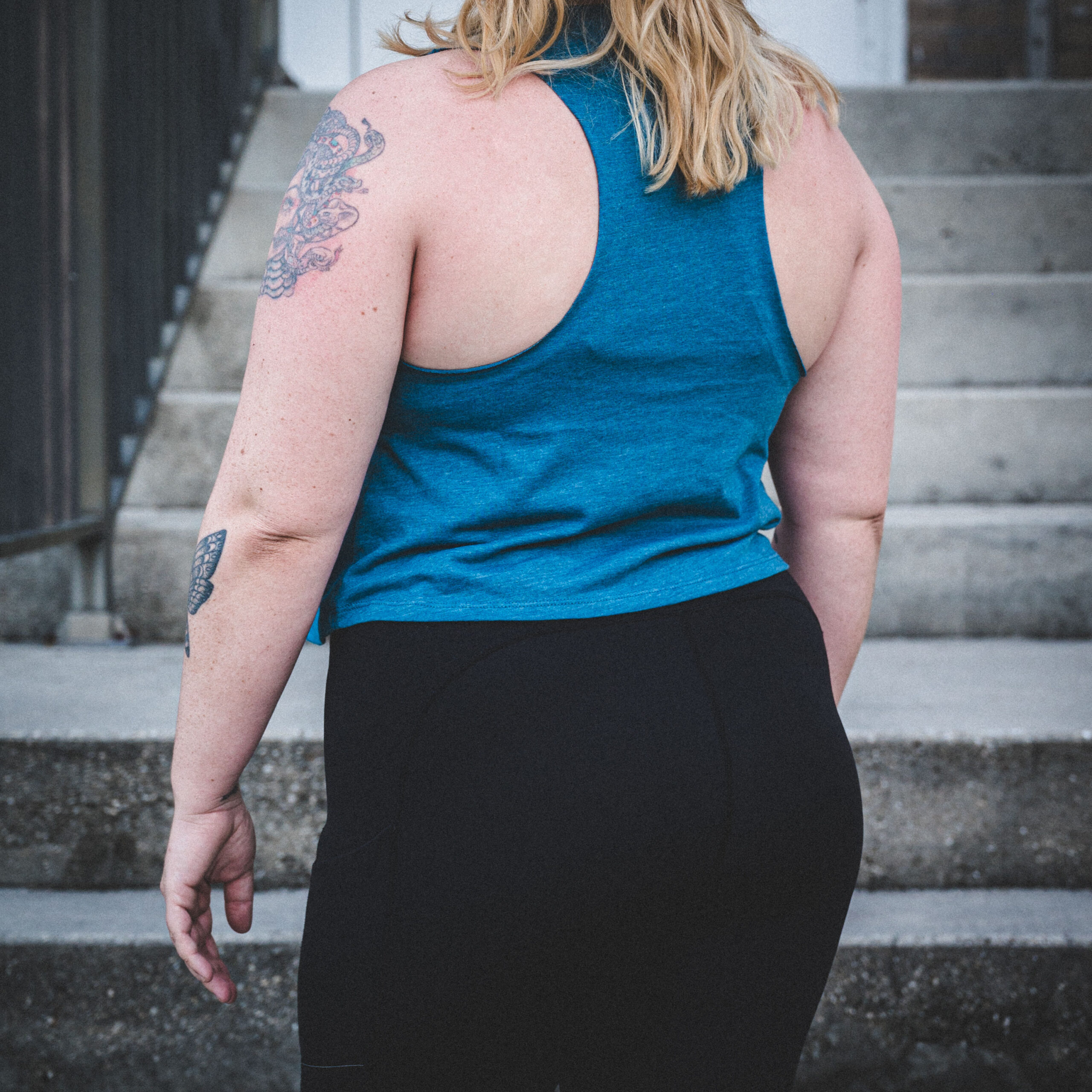 Women’s Teal Crop Top with wavy Corporate Ladder Wordmark.