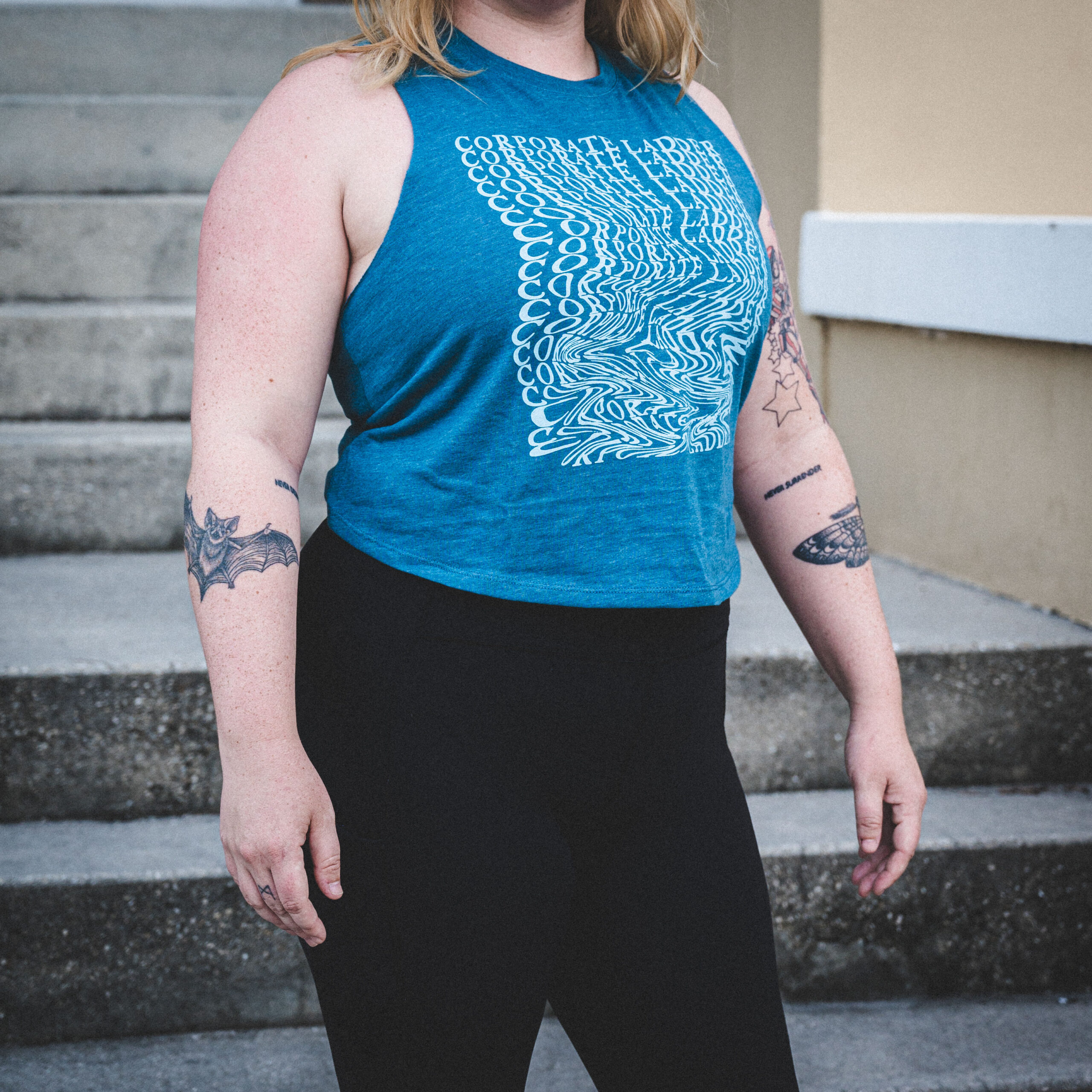 Women’s Teal Crop Top with wavy Corporate Ladder Wordmark.