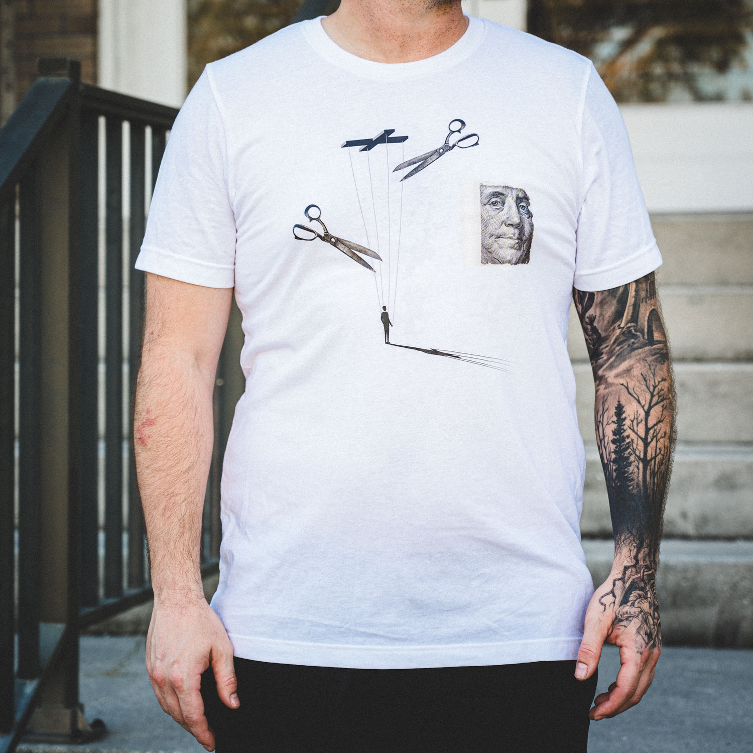 White Unisex Puppet Shirt with Scissors and Money Face on Front and Corporate Ladder Logo in Black on back.