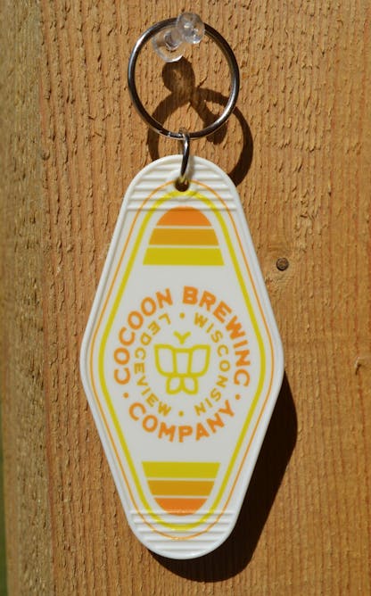 White keychain with yellow lettering