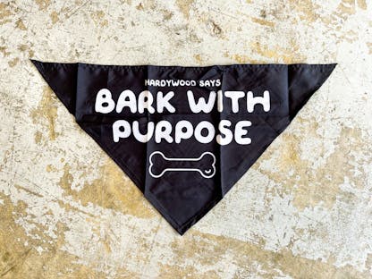 black pet bandana featuring "bark with purpose" text and bone design on a gray background