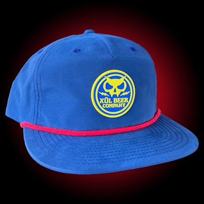 blue grandpa hat with yellow rubber patch with Xul name and fanghead logo and red rope across bill.
