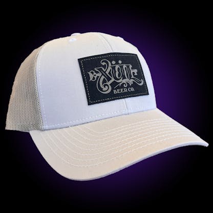 Trucker hat with white front and tan mesh back. Leather Xul Logo patch on the front.