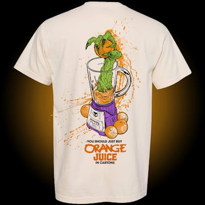 Ivory comfort colors tee with green creature arm reaching out of a blender with oranges in and around it