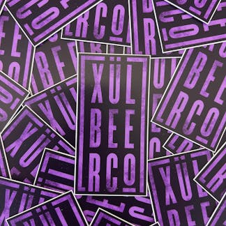 Purple and black sticker with Xul Beer Co. stacked.