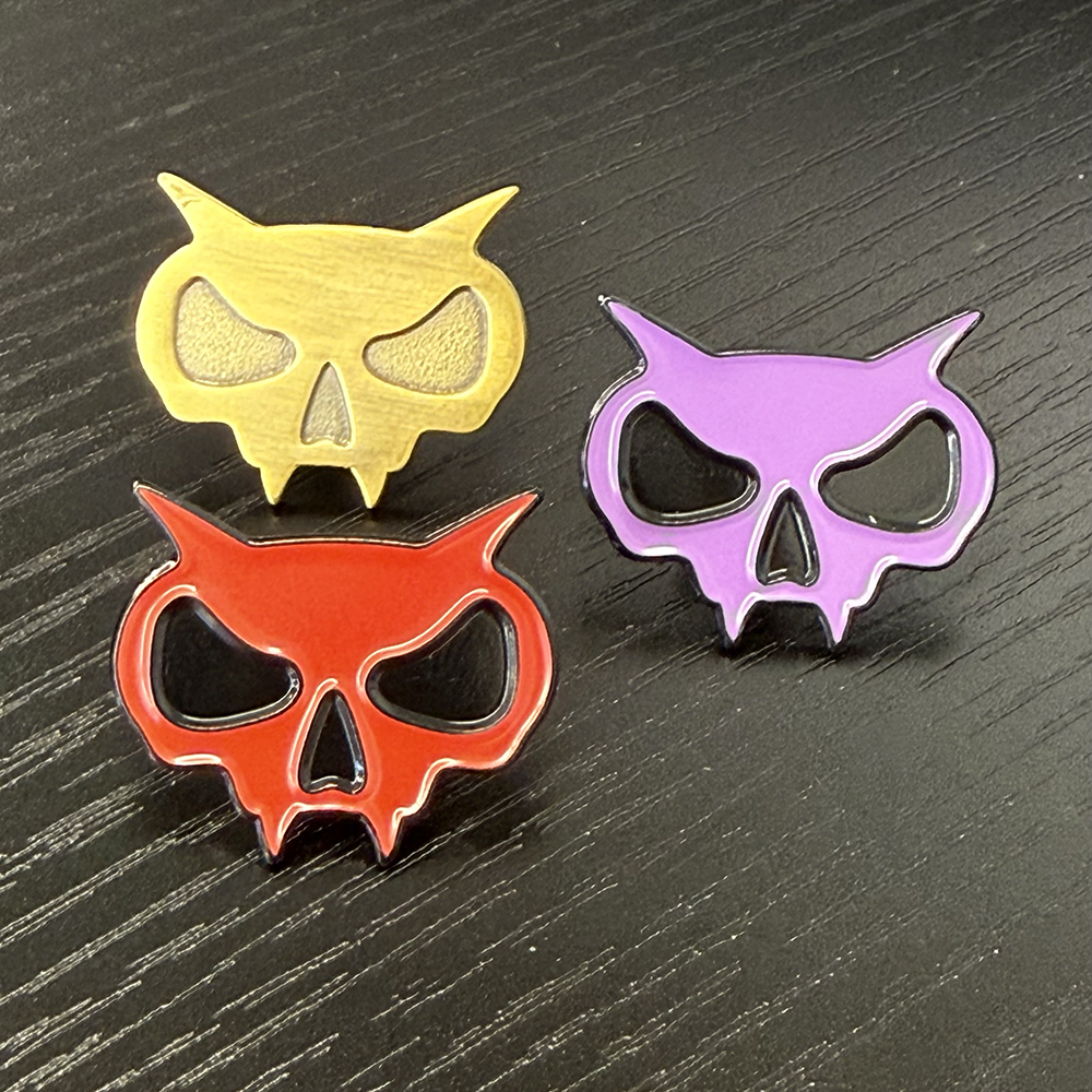 Xul enamel fanghead pins.