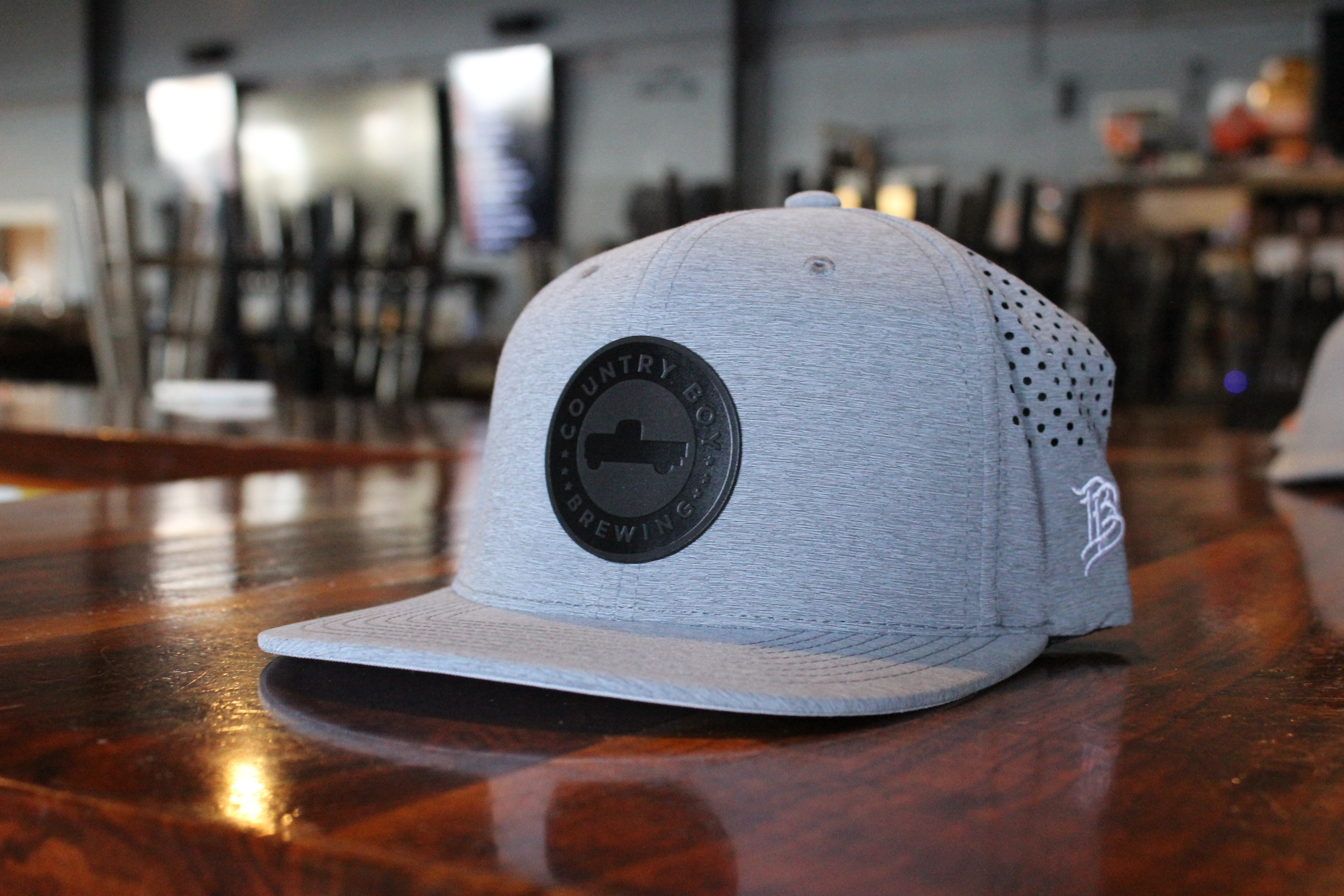 Grey Branded bills hat with black country boy logo in the front center as a circle.
