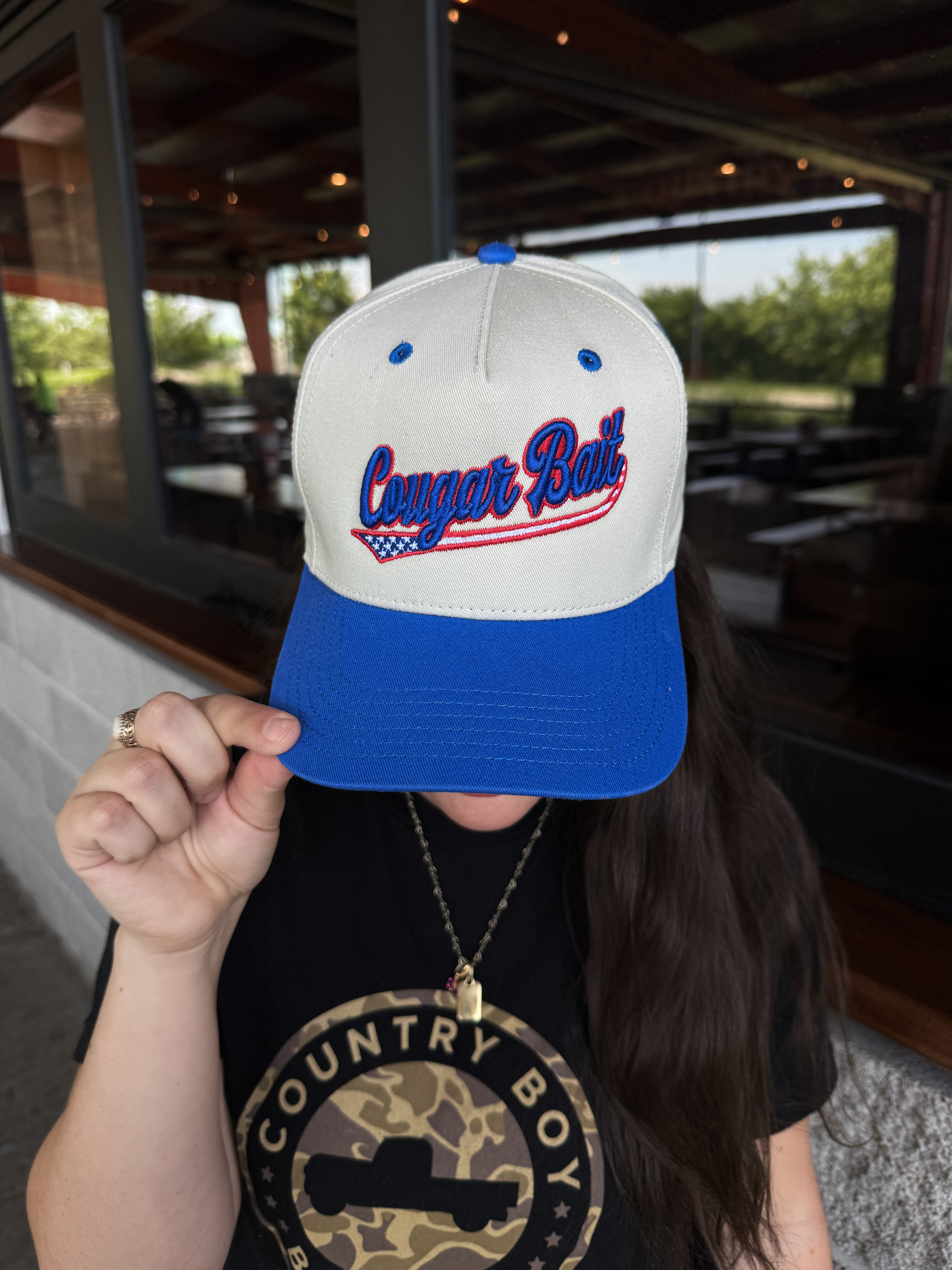 White Cap, Blue Bill, Cougar Bait written on front in blue letters.