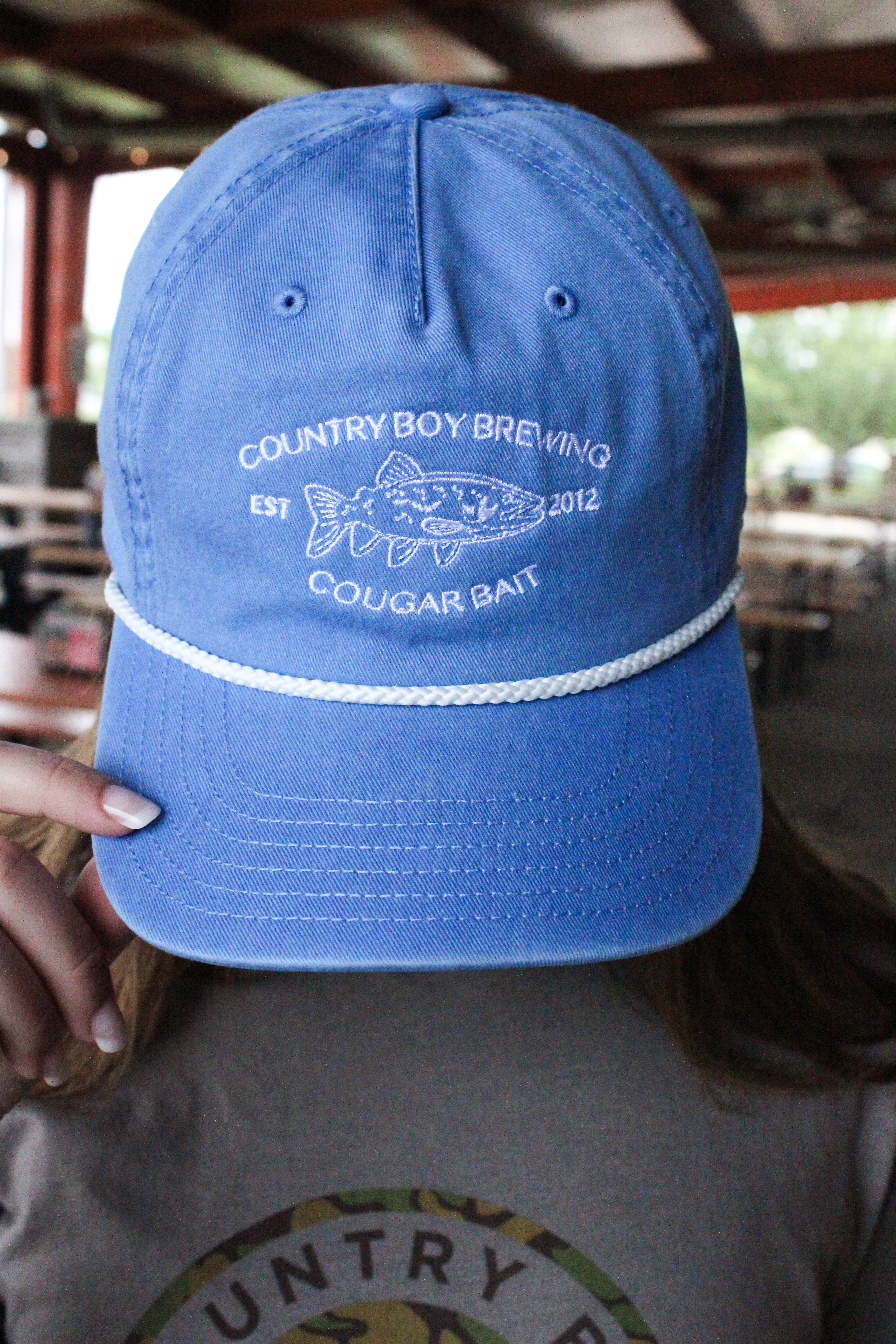 Blue Cougar Bait Skully Cap - Country Boy Brewing on hat , fish in middle with date company was founded.
