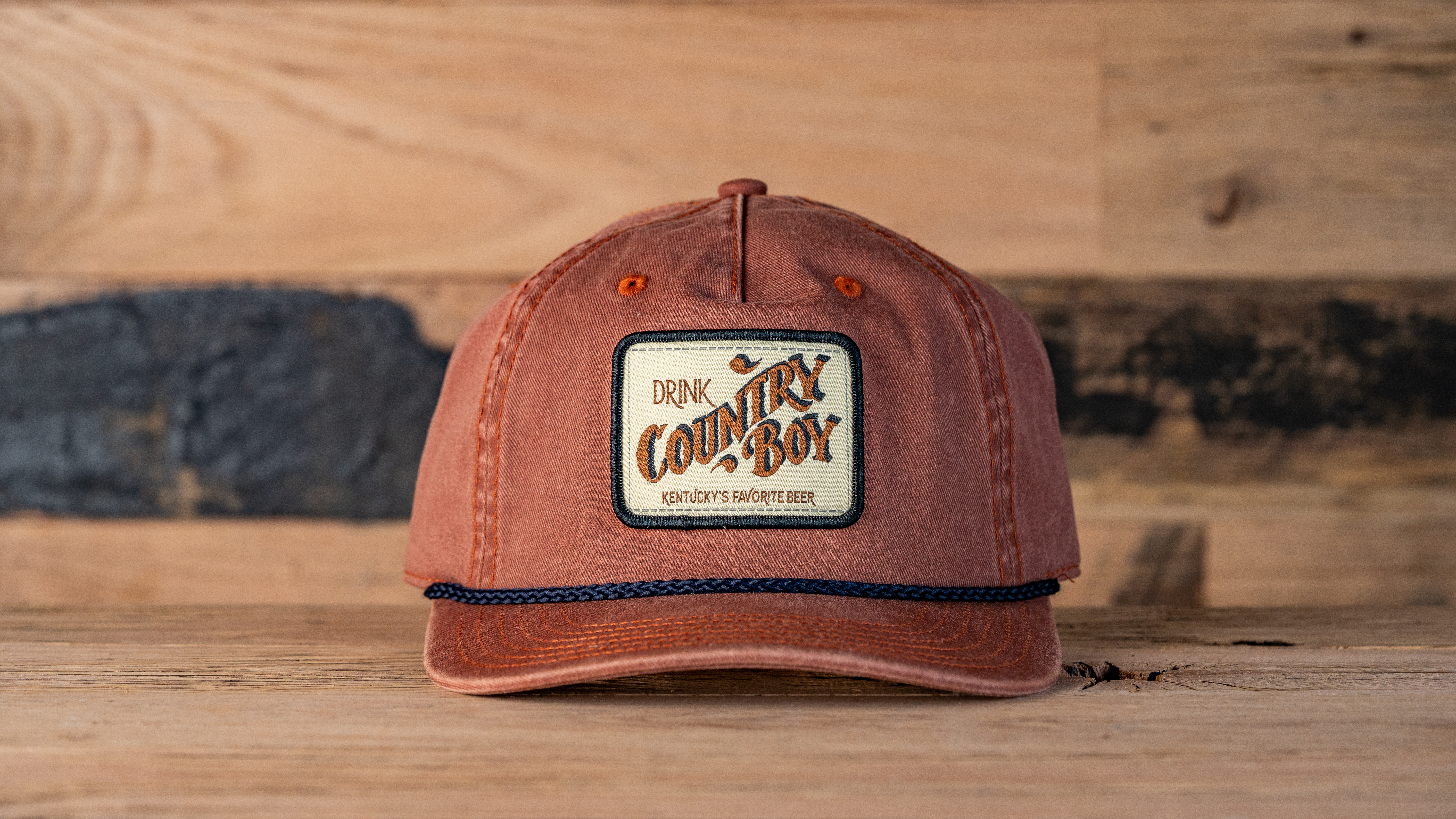 Orange hat, Blue Cord, Drink Country Boy patch in center front.