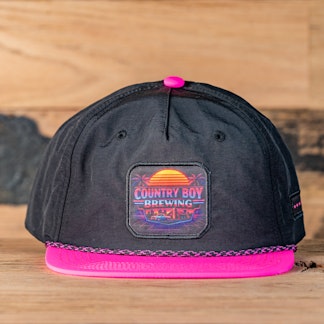 Black hat, pink brim, Country Boy Brewing logo on square patch with sunset over ocean.