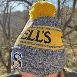 navy and gold stocking cap that says Schells brewery.