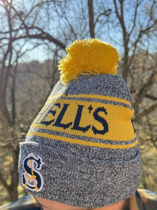 navy and gold stocking cap that says Schells brewery.
