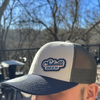 Grey and navy blue baseball hat with Schell patch on front.