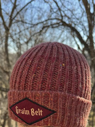 Red fleck stocking cap with Grain Belt patch on front.