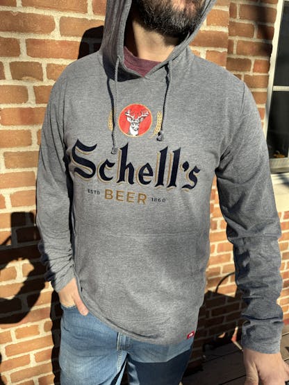 Grey light weight hood that says Schells on front.