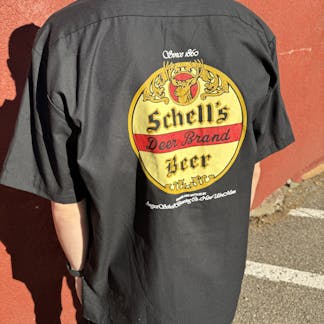 Black button up shirt with Schell logo on front and back.