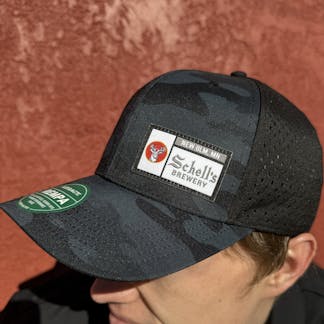 Black camo baseball hat with Schell patch on front.