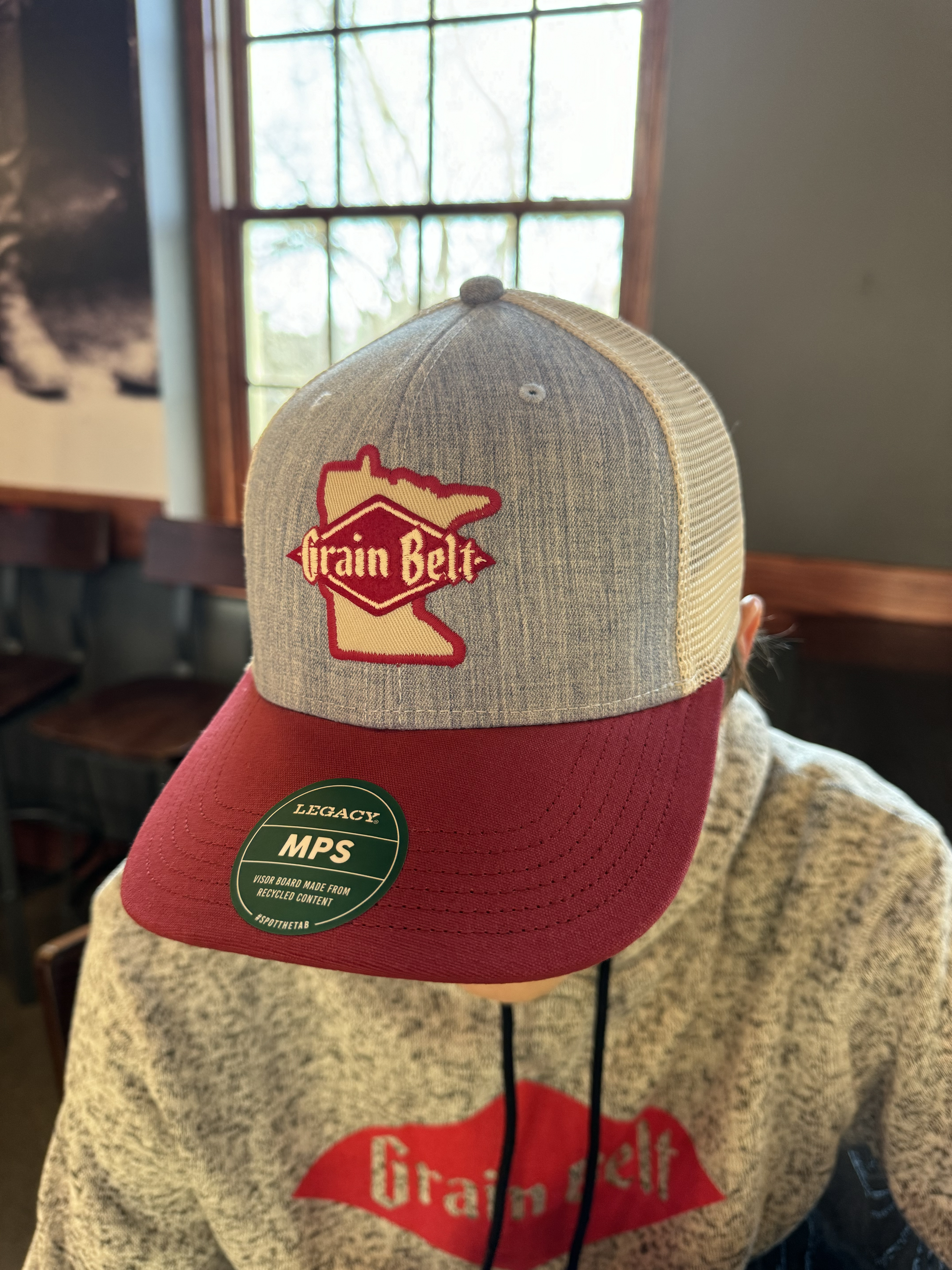 Grey and red baseball hat with Grain Belt Minnesota patch on front.