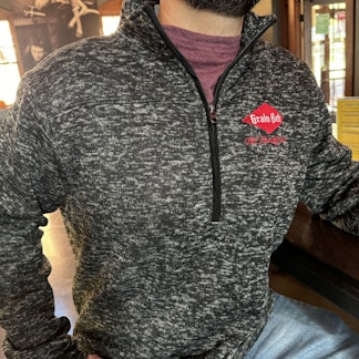 Charcoal grey half zip with red Grain Belt logo.