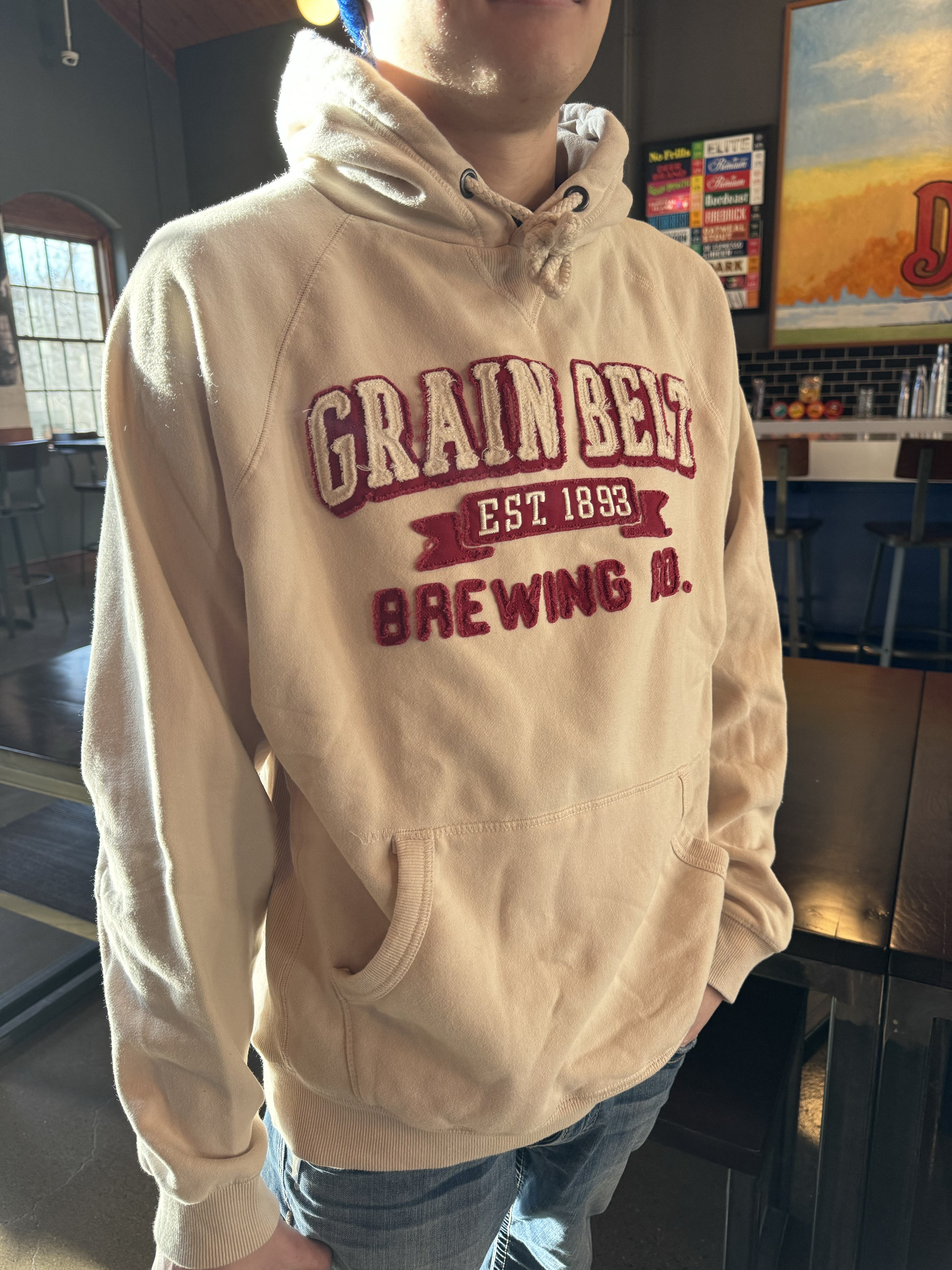 Cream colored hood with red raised letters that say Grain Belt.