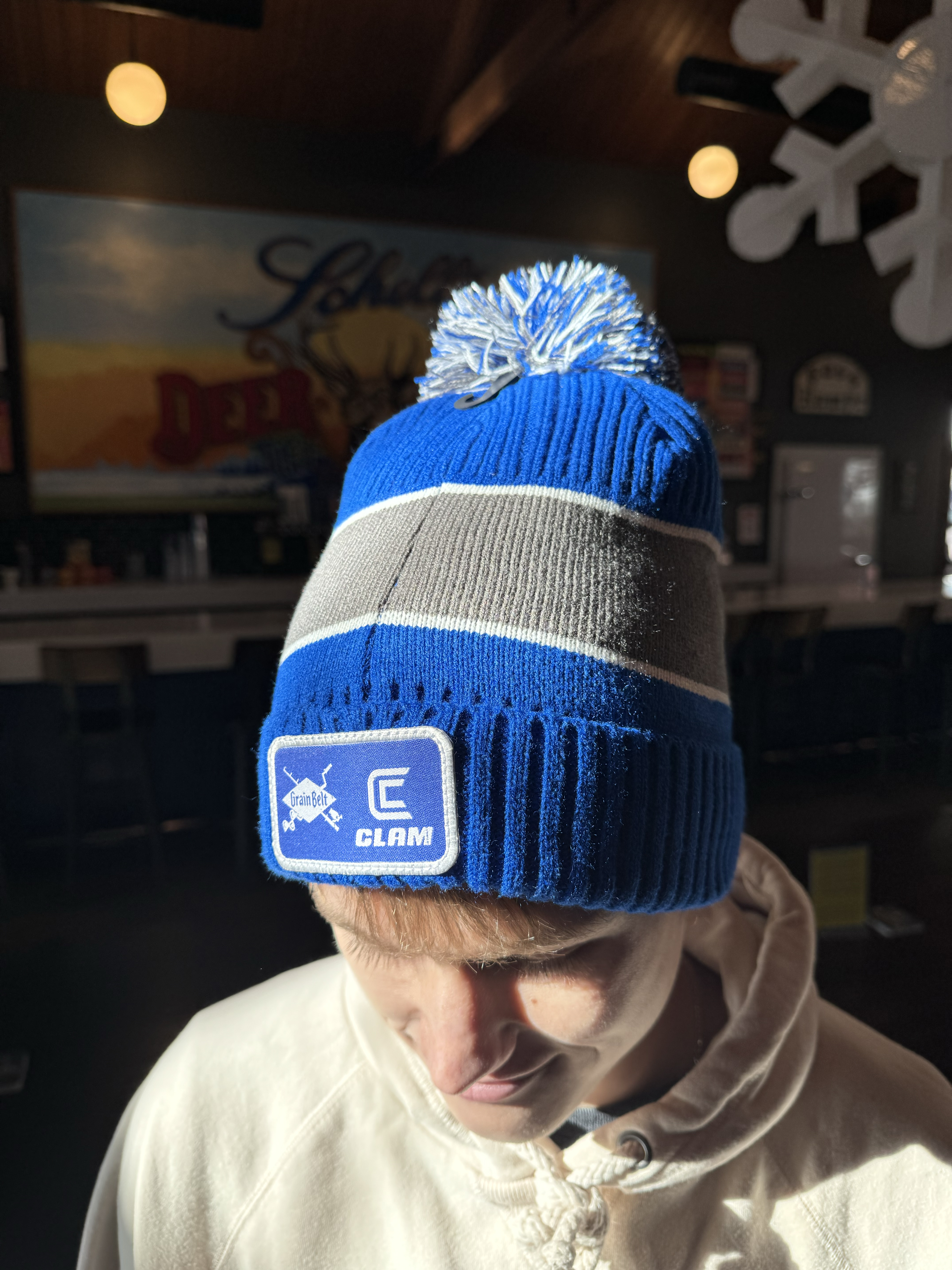 Blue and grey stocking cap with a Grain Belt patch on one side.