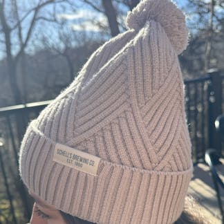 Tan stocking cap with small Schell patch.