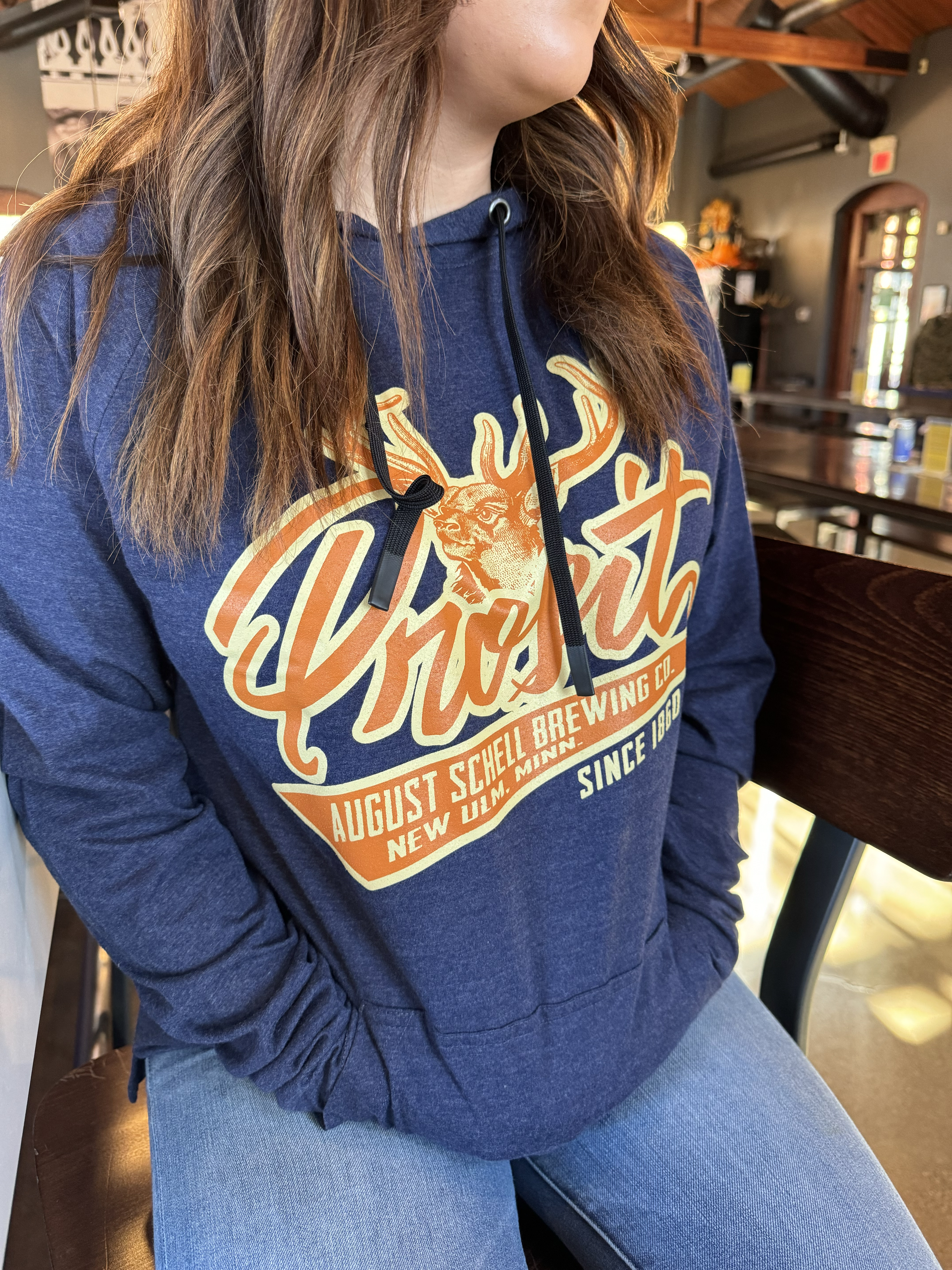 Blue light weight hood with orange Prost on front.