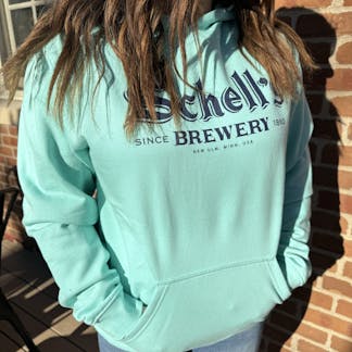 Teal colored hood with blue Schell logo on front.