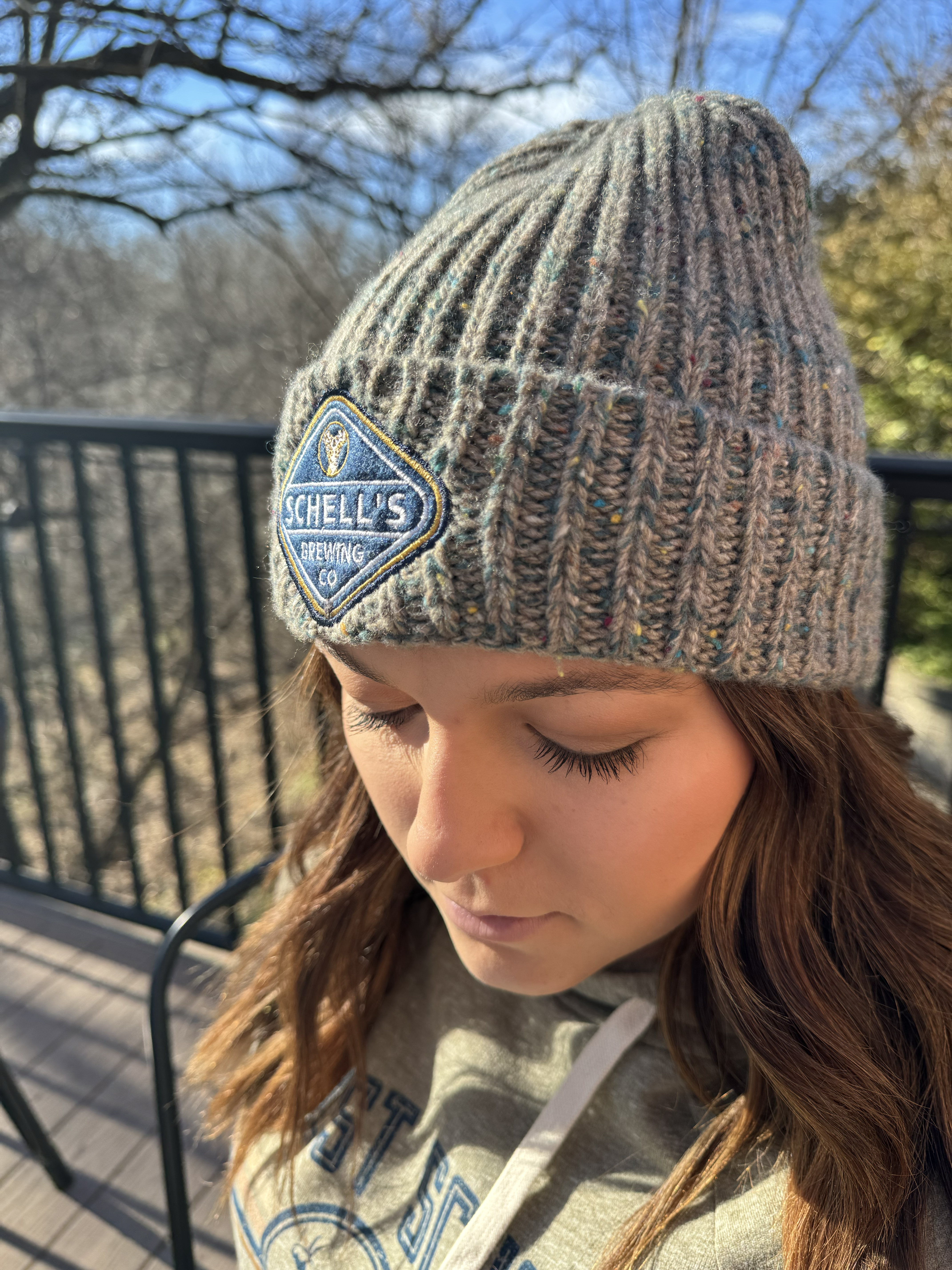 Blue and grey fleck stocking cap with Schell patch on front.