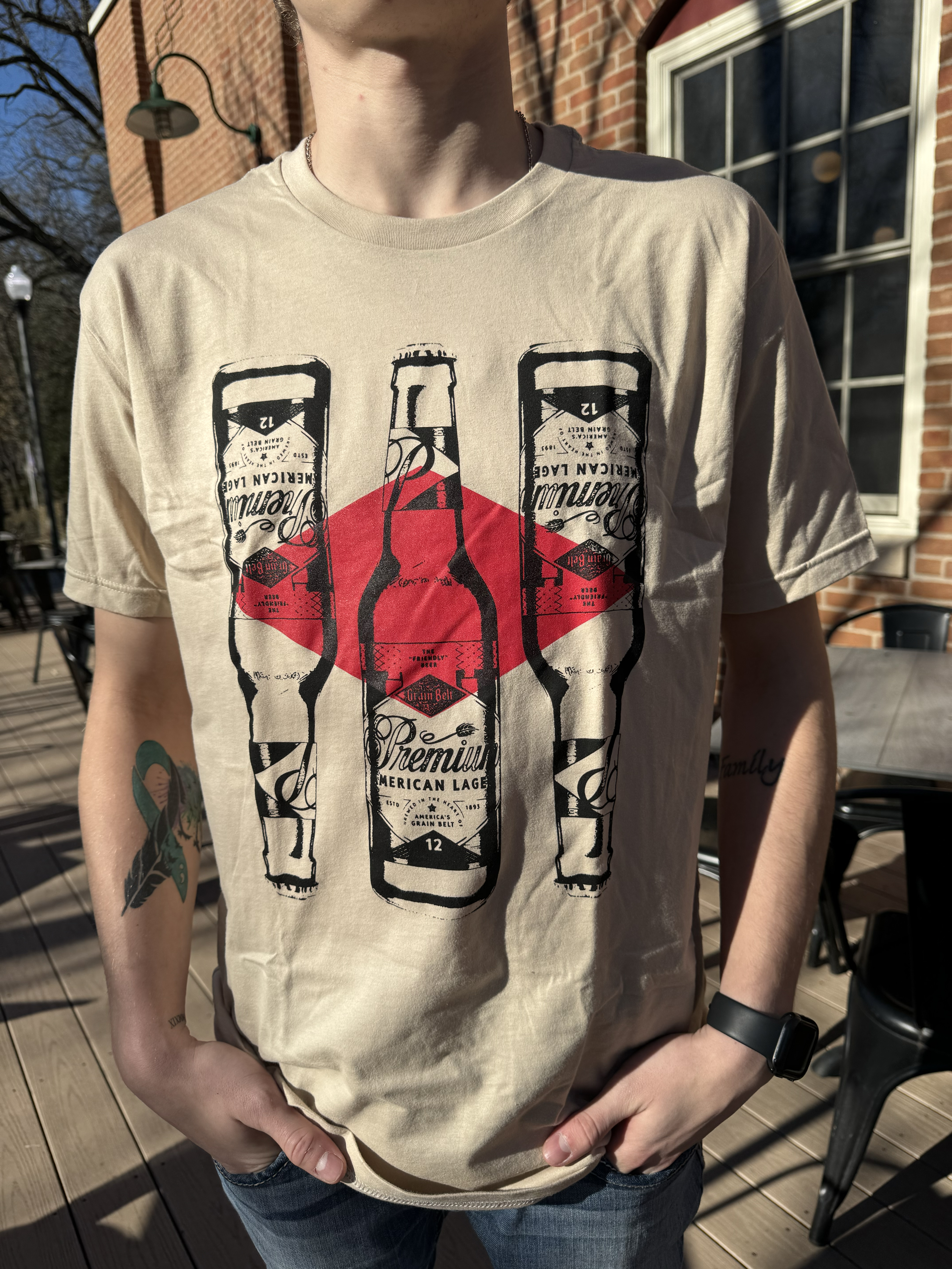 Tan T-shirt with three Grain Belt bottle logos on front.