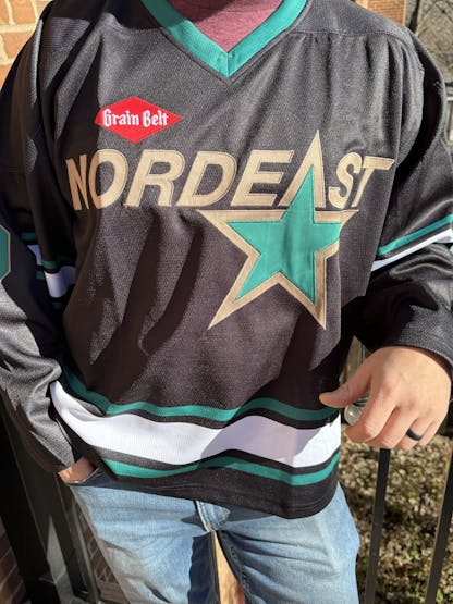 Black and green hockey jersey that says Nordeast.
