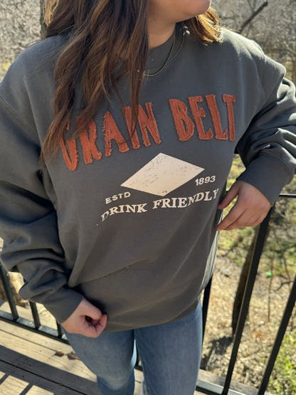 Pewter colored crew with red raised letters that say Grain Belt.