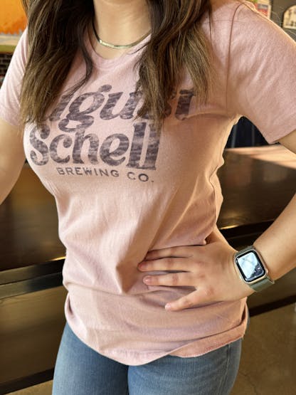Dust pink t-shirt with Schell logo on front.