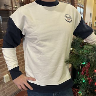 White and blue crew neck sweatshirt with Schell logo on front.