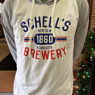 White hoodie with grey sleeves and a red, white, and blue Schell logo on front.