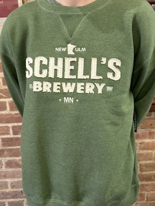 Green crew sweatshirt with white raised letters on front that say Schell's.