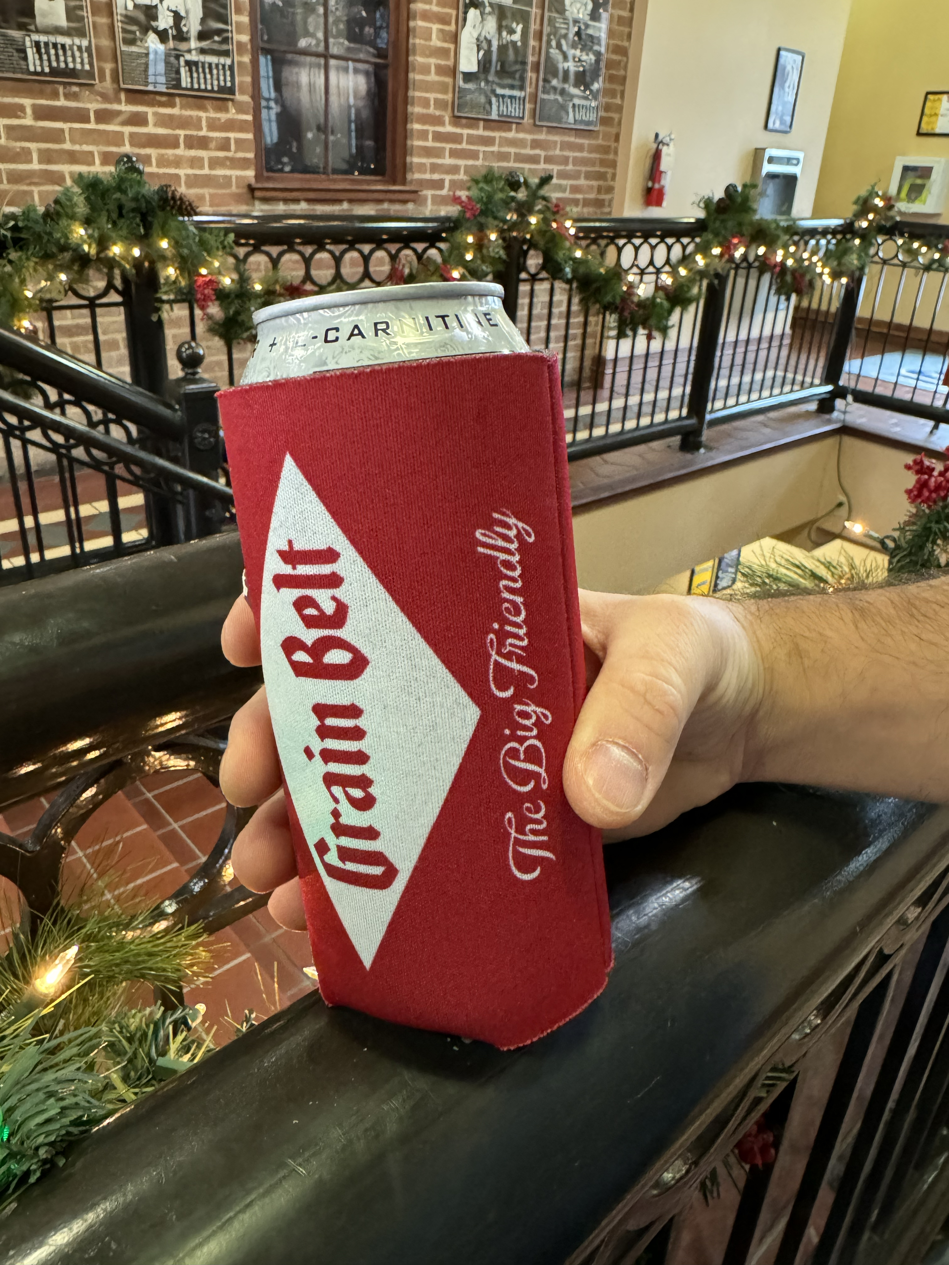 Red can coozie with Grain Belt logo on both sides.