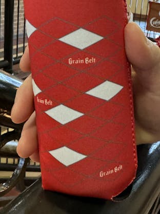 Red can coozie with Grain Belt diamond logos wrapper around sides.