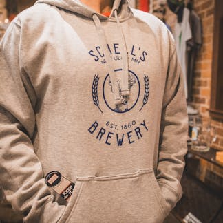 Grey hooded sweatshirt with Schell logo on front and bottle coozie inside front pocket.