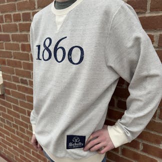Light grey crew neck sweatshirt with "1860" in navy on front with a patch on the lower left.