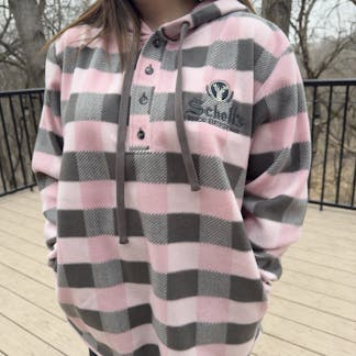 Pink and grey plaid henley style sweatshirt with Schell logo on left lapel.
