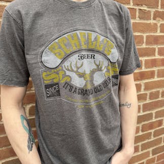 Grey t-shirt with Schell logo on front.