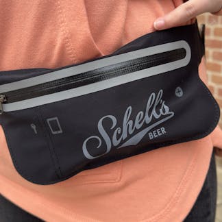 Black waist pack with Schell logo on front.