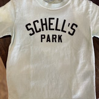Teal colored kids t-shirt with Schell park logo on front.