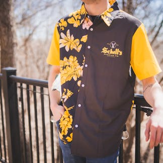 Gold and black Hawaiian style shirt with Schell logo on left lapel.