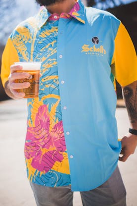 Gold and blue Hawaiian style shirt with Schell logo on left lapel.